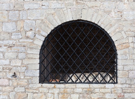 natural stone wall with wrought grating at the Adriatic coastの写真素材