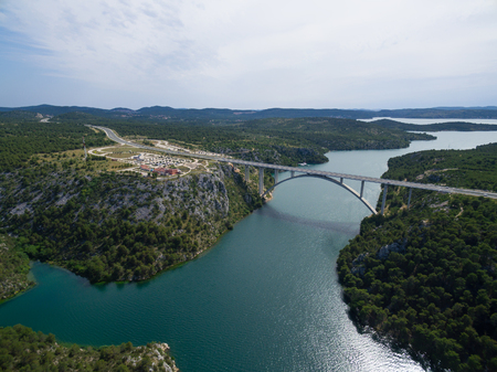 Aerial view of the Krka Bridge - 391 meters long concrete arch bridge. Krka river, Croatia.の写真素材
