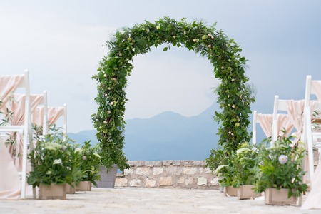 decorated arch and chairs at the wedding venueの写真素材