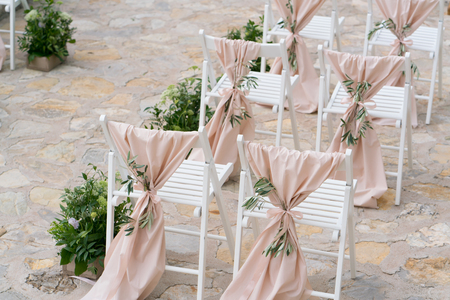 decorated chairs at the wedding venueの写真素材