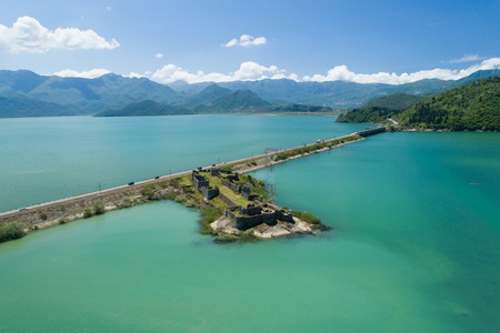 Aerial view of Skadar lake, dam and island with old medieval fortress Lesendro, Montenegroの写真素材