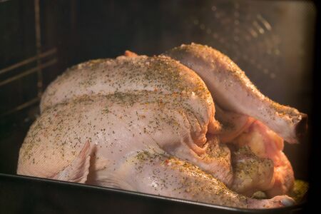 Cooking chicken in the ovenの写真素材