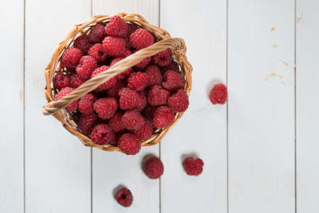 raspberries in the basket on white backgroundの写真素材
