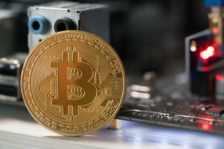 bitcoin against the background of the motherboard in the rack for the crypto currency miningの写真素材