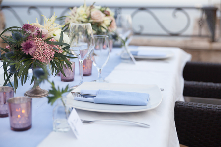 table set for a wedding dinner on the terrace of the restaurantの写真素材