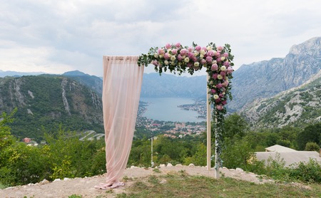 Beautiful wooden wedding arch decorated with flowersの写真素材