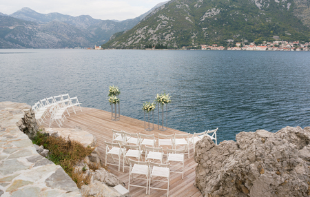modern stands with flowers on the background of the sea for the wedding ceremonyの写真素材
