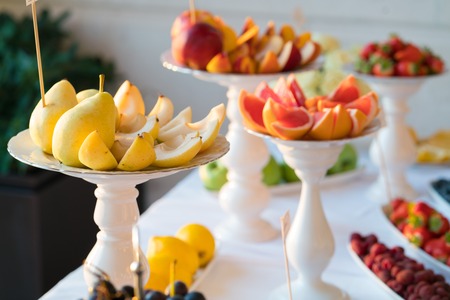 Banquet table full of fruits and berriesの写真素材