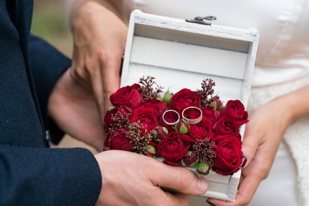 jewelry box with wedding rings decorated with fresh flowers