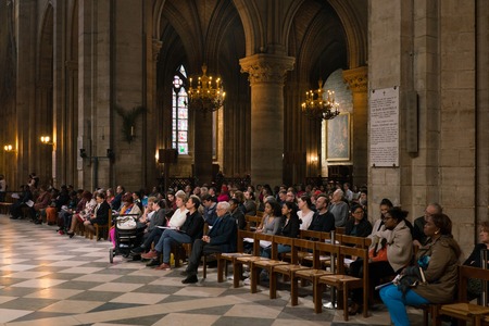 Paris, France - March 31, 2019: parishioners in the cathedral Notre Dame de Paris.のeditorial素材