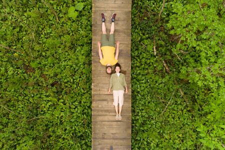 couple of lovers lying on a wooden bridge in the forestの写真素材