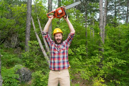 bearded lumberjack with a chainsaw makes faces