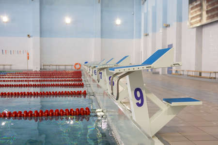 Start position with number 9 in competition swimming pool On a blurred background, a swimming pool is visibleの写真素材
