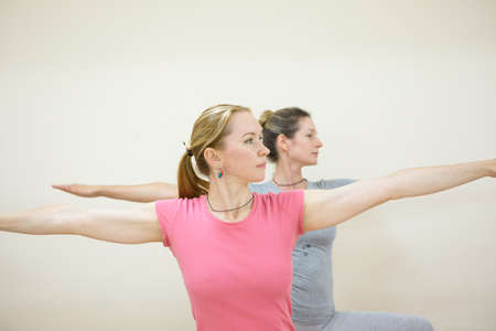 Group of positivel people practicing yoga in gym Teamwork, good mood and healthy lifestyle conceptの写真素材