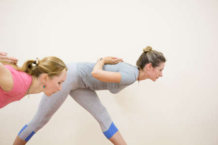 Group of positivel people practicing yoga in gym Teamwork, good mood and healthy lifestyle conceptの写真素材