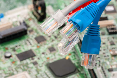 Modem router network hub with cable connecting. Bright blue and red cables and connectors. Close-up