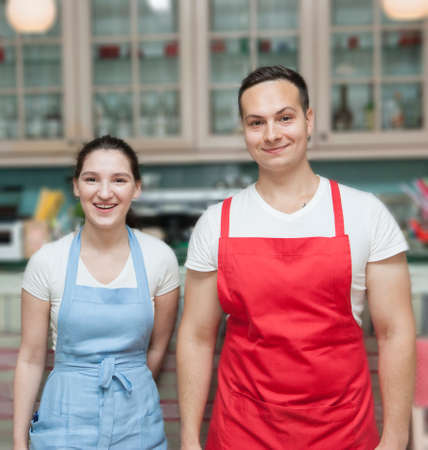 Waiters in a fashionable cafe Young, positive, motivated employees serve visitors