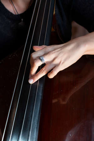 Hands of a musician playing on a contrabass closeup Limited depth of field