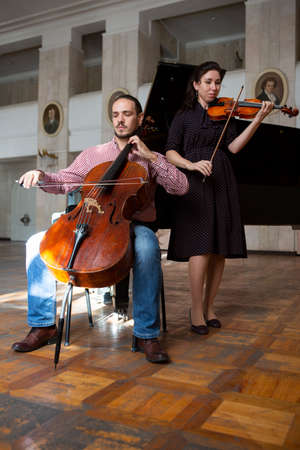 Two violinists performing together hands close up, classical music concertの写真素材