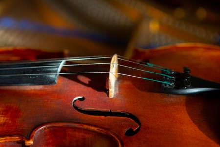 violin in vintage style on wood background close up, classical music concert