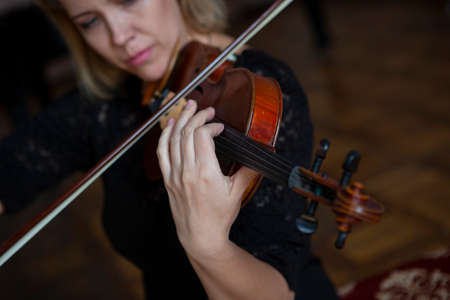 Violin player violinist classical music playing. Orchestra musical instruments Close-up portraitの写真素材