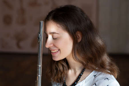 Beautiful young woman with flute Genre portrait of young beautiful girlr Close-upの写真素材