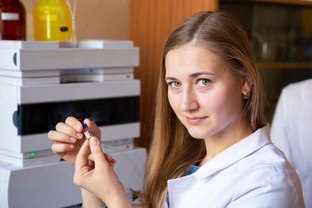 Young scientist works in modern biological lab Young female research scientist preparing and...
