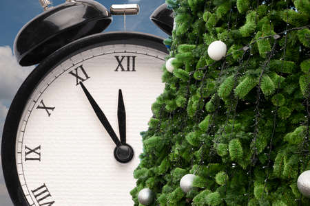 Christmas gift box, alarm clock and fir tree branch View with copy space Card Close-up