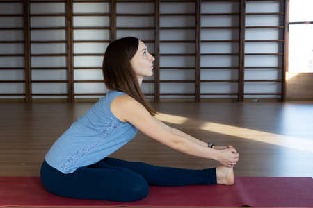 Beautiful woman practicing yoga indoors Relaxation and meditation.の写真素材