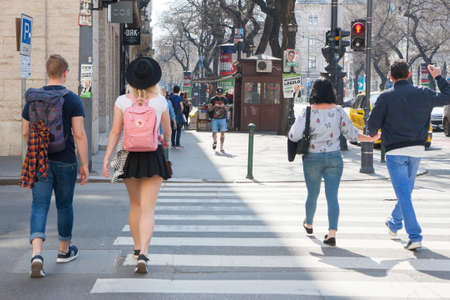 Budapest, Hungary - April 9, 2018: People on the streets of the city. Crosswalk. Traffic light. people crosses the road on a red traffic light.のeditorial素材