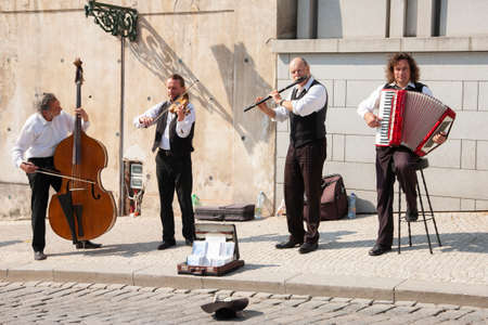 Prague, Czech Republic - April 19, 2011: Quartet of Musicians playing musical instruments for tourists on the street in Prague Genreのeditorial素材