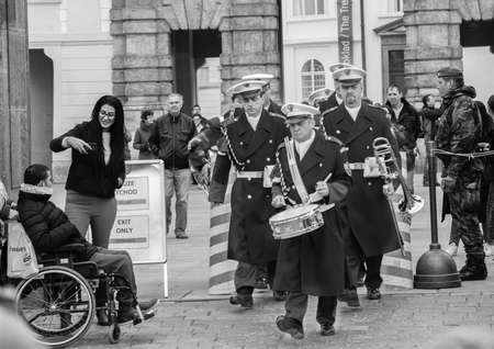 Prague, Czech Republic - March 13, 2017: Military musicians are passing by tourists Portrait Black and white imageのeditorial素材