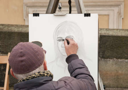 Prague, Czech Republic - March 14, 2017: Street portrait artist sketch a woman Genreのeditorial素材