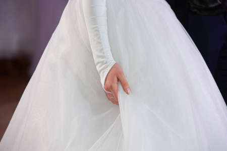 Wedding theme, holding hands newlyweds White gloves Close-upの写真素材