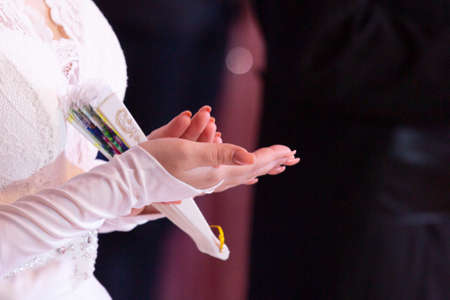 Wedding theme, holding hands newlyweds White gloves Close-upの写真素材