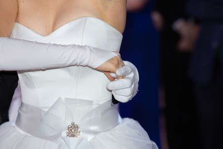 Wedding theme, holding hands newlyweds White gloves Close-upの写真素材