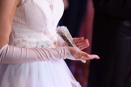 Wedding theme, holding hands newlyweds White gloves Close-up