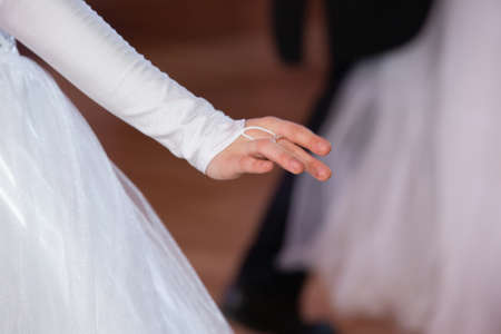 Wedding theme, holding hands newlyweds White gloves Close-upの写真素材