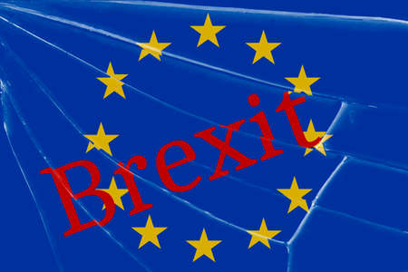 The text Brexit on the broken glass. The concept of a UK exit from the European Union Background