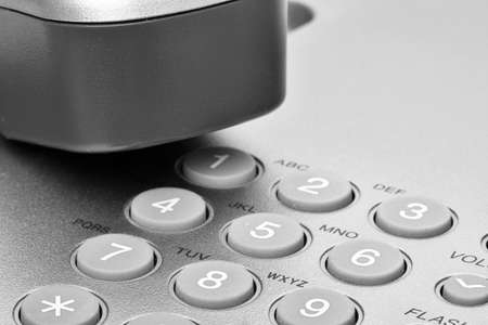 Office telephone. Detail of earpiece and keypad. Wired desktop telephone