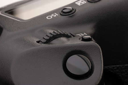 Close-up macro shot of a modern digital SLR camera. Detailed photo of black camera body with a...