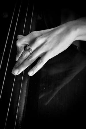 Hand of a musician playing on a contrabass closeup Limited depth of fieldの写真素材