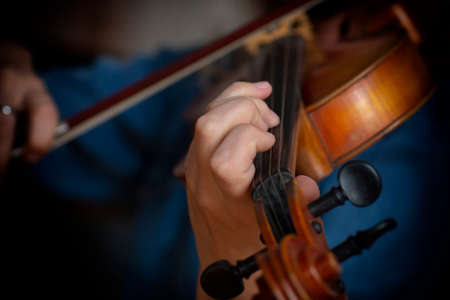Violin player violinist classical music playing. Orchestra musical instruments Close-up