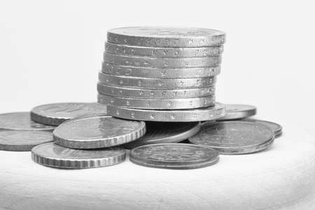 Euro coins stacked on each other in different positions. Selective focus Close-up Black and white imageの写真素材