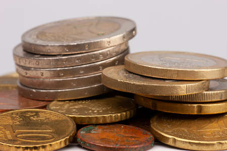 Euro coins stacked on each other in different positions. Selective focus Close-up
