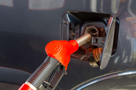 Fill the car with fuel. The car is filled with gasoline at a gas station. Gas station pump. Man...