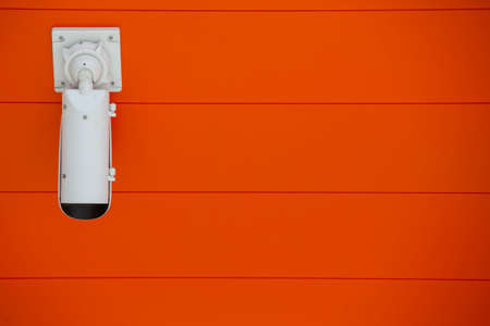 Modern security camera fix on the indoor concrete wall Limited depth of field. Blurred imageの写真素材