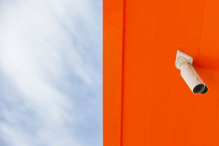 CCTV security cameras on pole on blue sky with white clouds background Limited depth of field. Blurred imageの写真素材