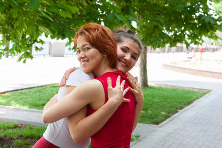 Holiday woman doing yoga pose meditation in the public park Sport Healthy concept. Portraitの写真素材