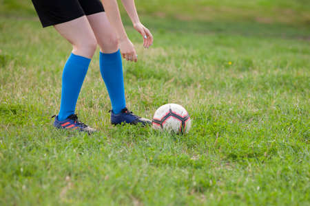 Stylish girls in a sportwear. Cute woman with ball. Girl play in soccer Portrait